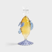 unique yellow candle holder with a fish-shaped design, adding a whimsical touch to home décor