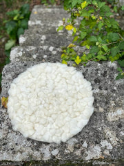 Handmade round cushion with sheep knots