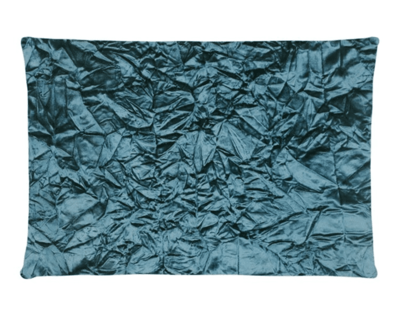 A teal cotton cushion