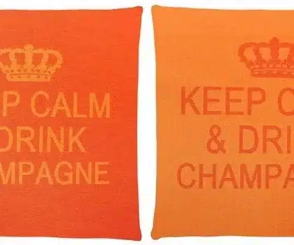 2 orange cotton cushions with a phrase Keep Calm & Drink Champagne on it