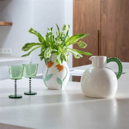 White jug with green handle