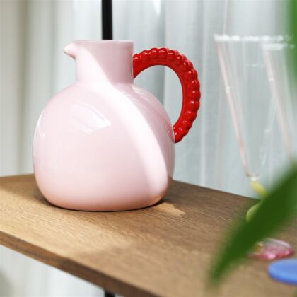 Pink jug with a red pearl handle