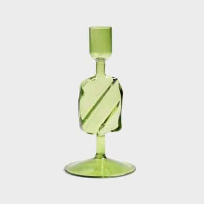 Green glass candle holder with a puddle shape